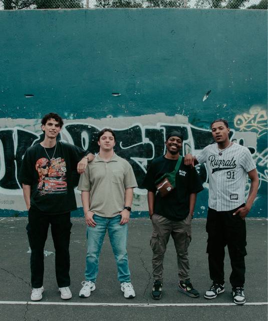 four guys in a band called "The E Block" posing for a picture